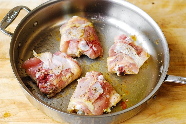 cooking chicken thighs in a skillet on medium-high heat