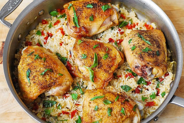 Mediterranean food, Mediterranean recipes, chicken rice with sun-dried tomatoes, basil, and Parmesan cheese, best chicken rice, gluten free chicken dinners, how to cook chicken thighs, Italian chicken and rice