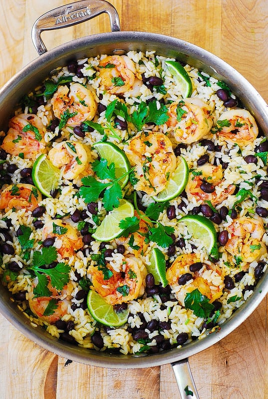 Black bean and cilantro-lime shrimp with rice in a stainless steel skillet