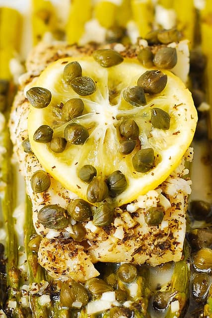 Baked Cod and Asparagus with Garlic Lemon Caper Sauce.