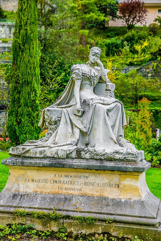 statue of a woman surrounded by luscious greenery in Montreux, Switzerland