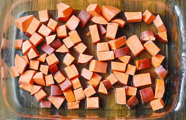 add chopped sweet potatoes to a baking dish