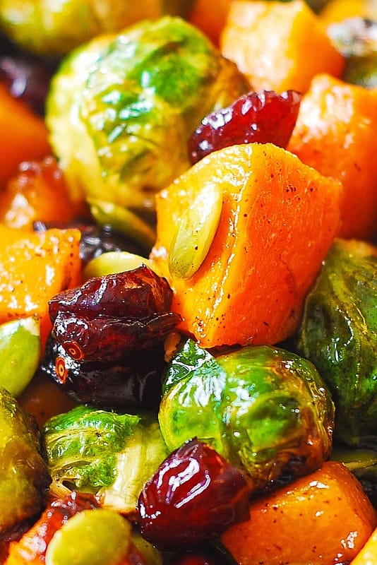 close-up of Thanksgiving salad with Roasted Brussels Sprouts, Maple Butternut Squash, Pumpkin Seeds, and Cranberries