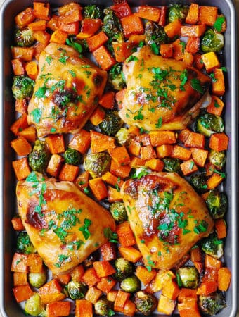 Sheet Pan Maple-Dijon Chicken with Butternut Squash and Brussels Sprouts on a baking sheet