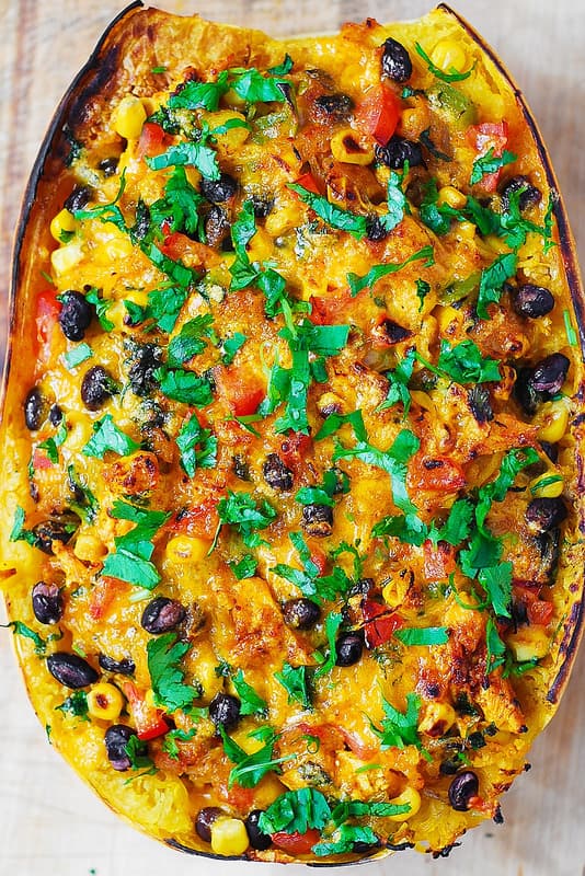 Southwestern Chicken Stuffed Butternut Squash with black beans, bell pepper, tomatoes, corn, green chilies, cheddar cheese, cilantro