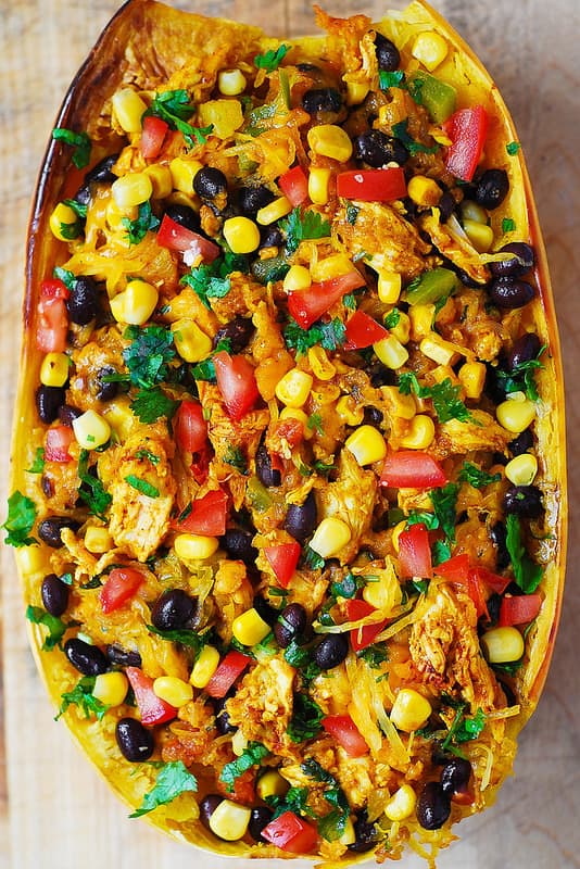 Southwestern Chicken Stuffed Butternut Squash with black beans, bell pepper, tomatoes, corn, green chilies, cheddar cheese, cilantro