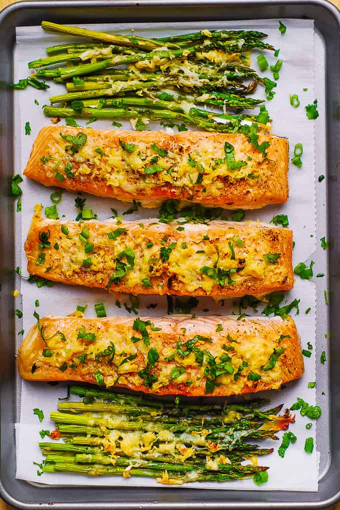 Parmesan Salmon and Asparagus on parchment paper lined baking sheet