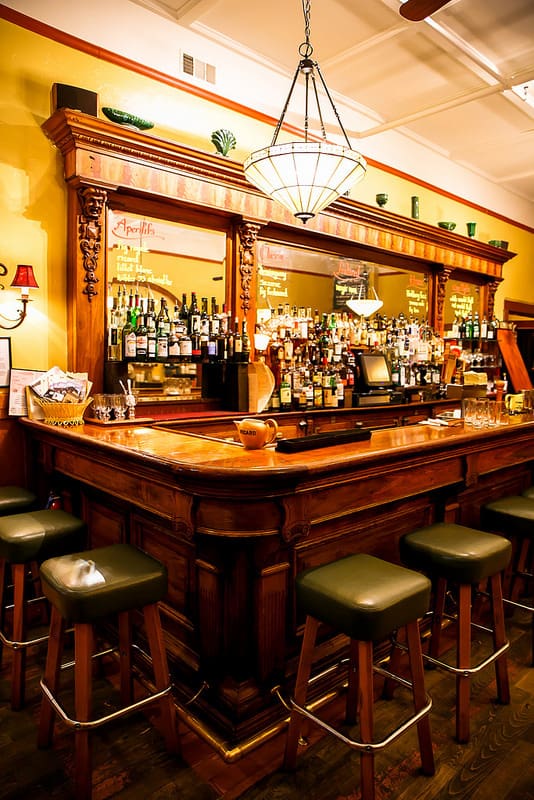 Antique wooden bar at the The Girl and The Fig Restaurant in downtown Sonoma, California.