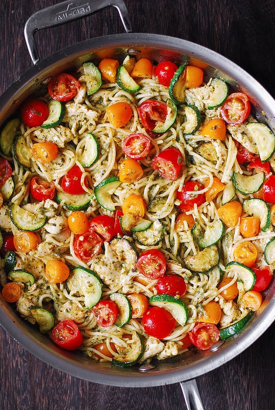 Chicken Spaghetti with Cherry Tomatoes, Zucchini, and Basil Pesto in a stainless steel skillet