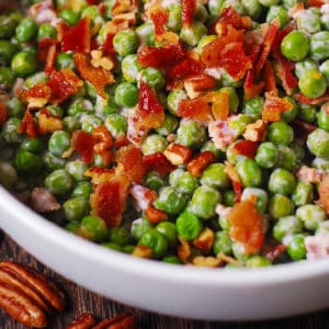 Creamy and crunchy salad with peas, bacon, and pecans