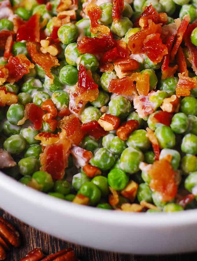 Creamy and crunchy salad with peas, bacon, and pecans
