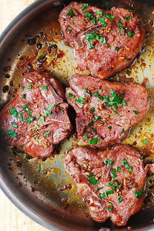 lamb loin chops in a stainless steel skillet