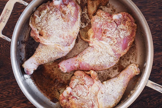coat chicken legs with flour mixture