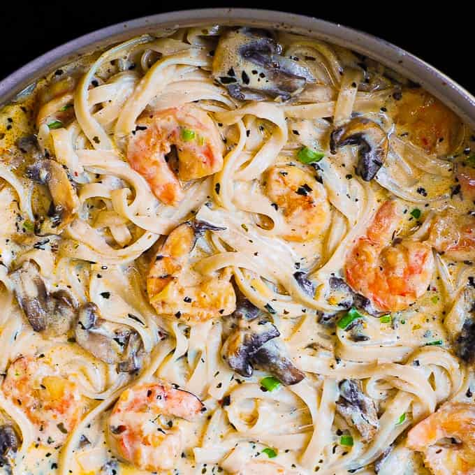 Creamy Shrimp Pasta with Mushrooms in a stainless steel skillet