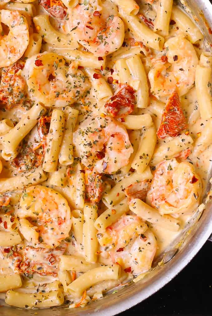 Shrimp Pasta with sun-dried tomatoes and creamy Mozzarella sauce in a stainless steel skillet