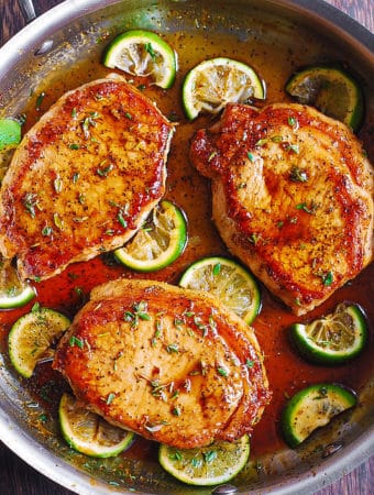 Pan Fried Pork Chops with Honey Lime Glaze - in a stainless steel skillet.