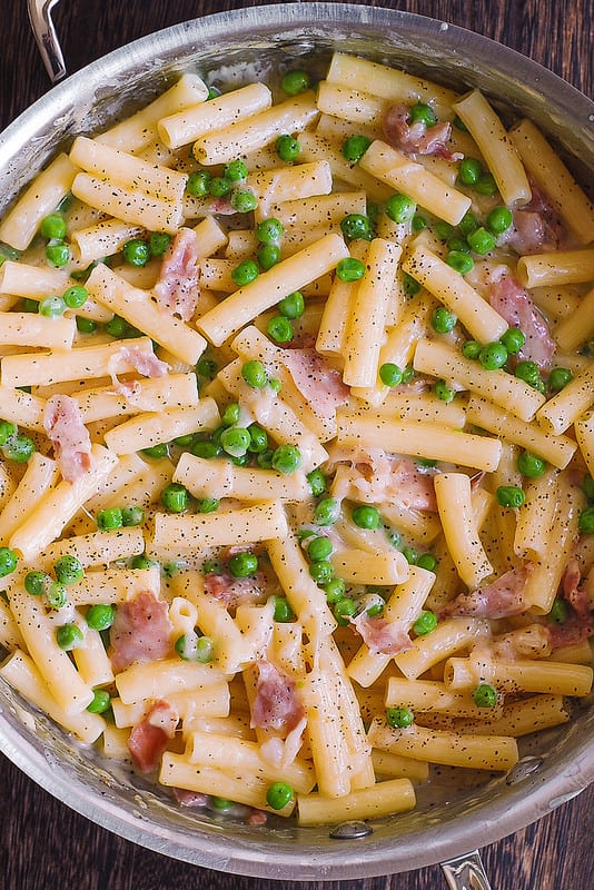 prosciutto pasta with peas in a stainless steel pan