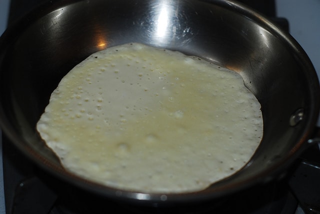 Crepes cooking on one side