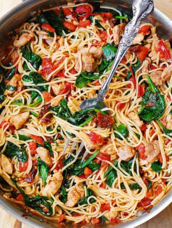 Tomato Spinach Chicken Spaghetti in a large stainless steel skillet