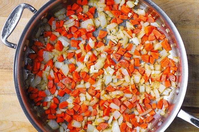 cook vegetables (carrots and onions) in a large skillet
