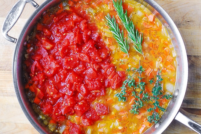 add tomato sauce, rosemary and thyme to the skillet 