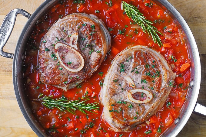 cook veal shanks in white wine and tomato sauce in a large skillet