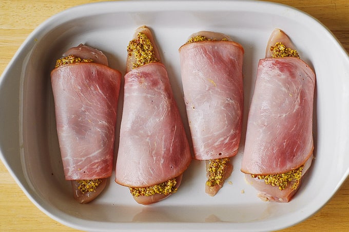 wrap ham slices over each chicken breast