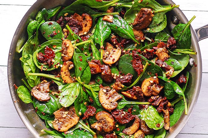 spinach, mushrooms, sun-dried tomatoes, garlic in a skillet