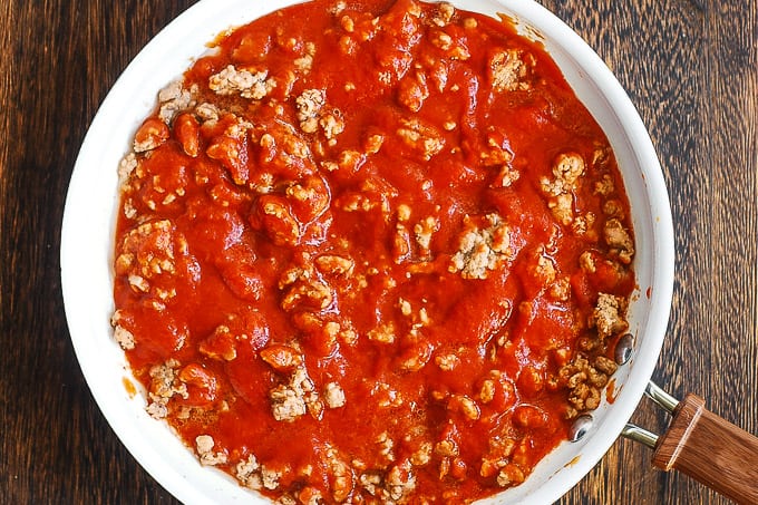 tomato sauce and sausage in a skillet
