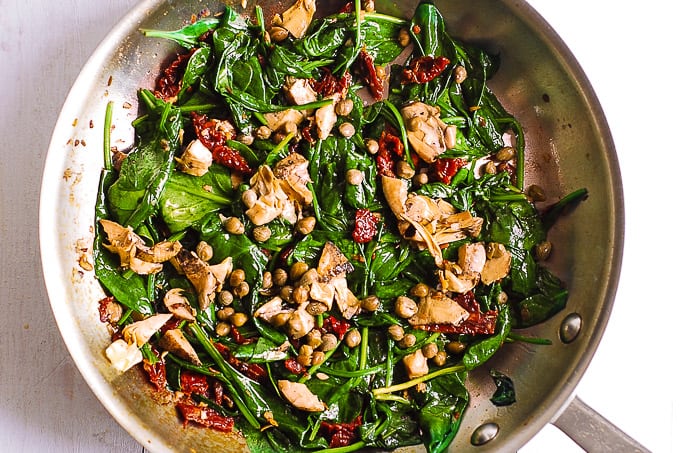 sauteed spinach with sun-dried tomatoes, garlic, artichokes, capers