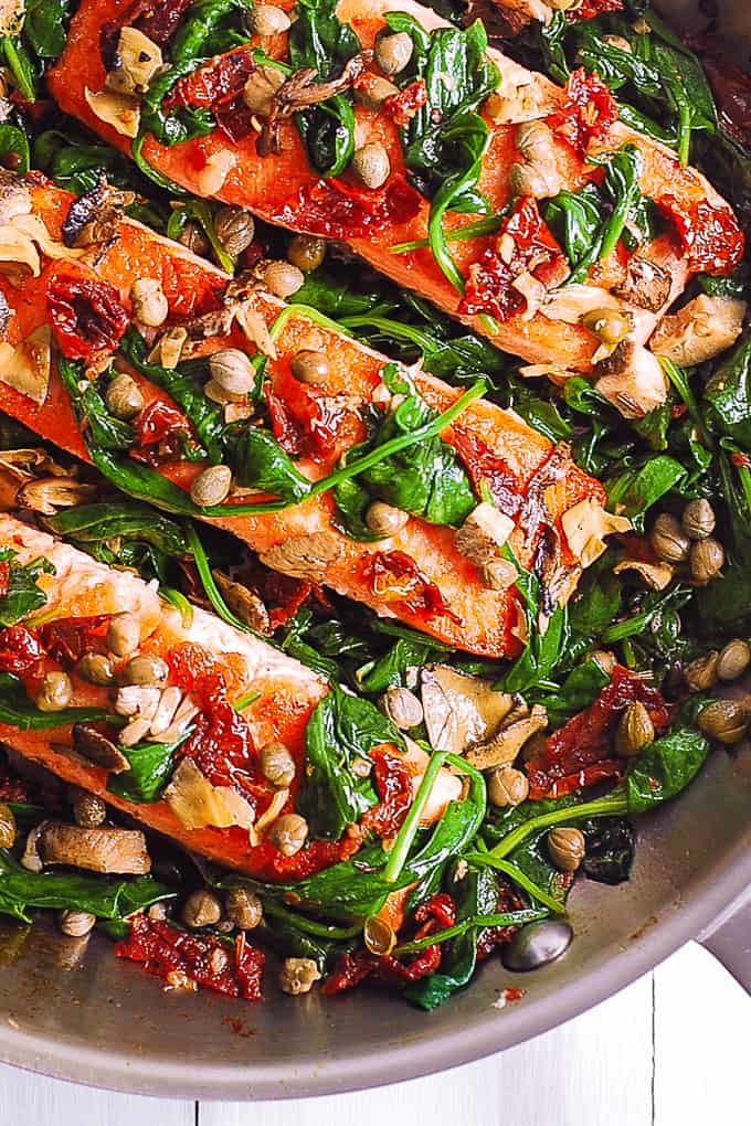 Pan-Seared Salmon with Spinach, Garlic, Sun-Dried Tomatoes, Artichokes, Capers