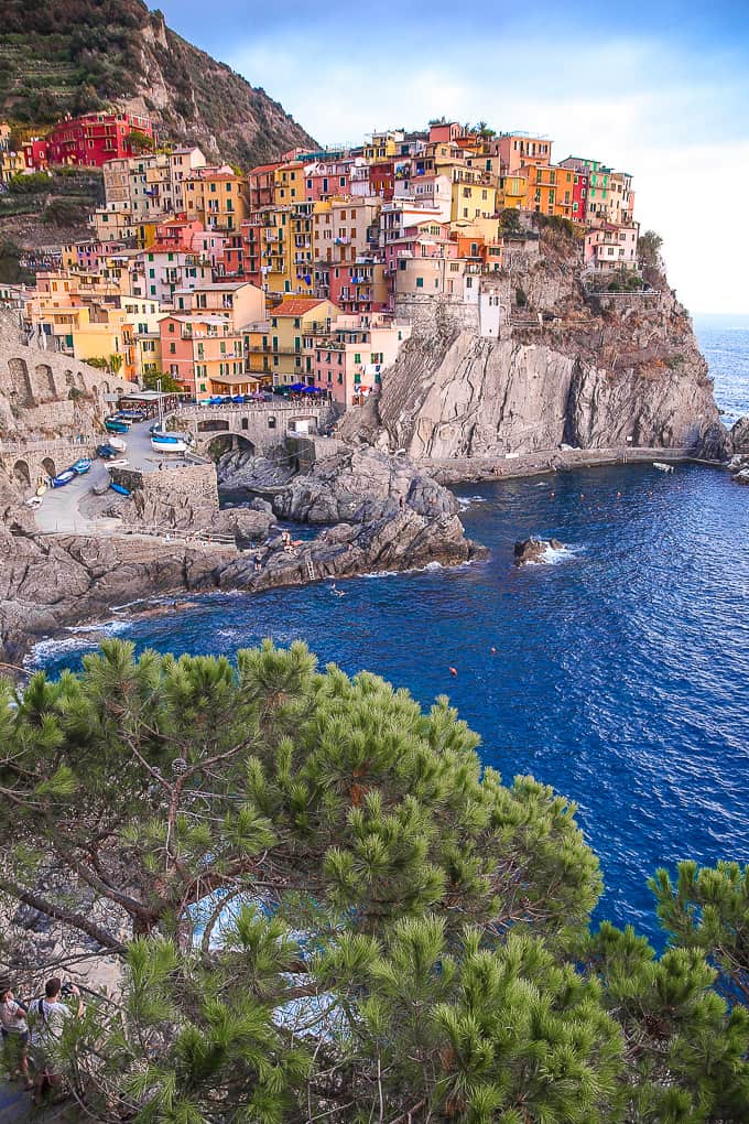 Colorful buildings on a cliff with the water below in Manarola, Italy