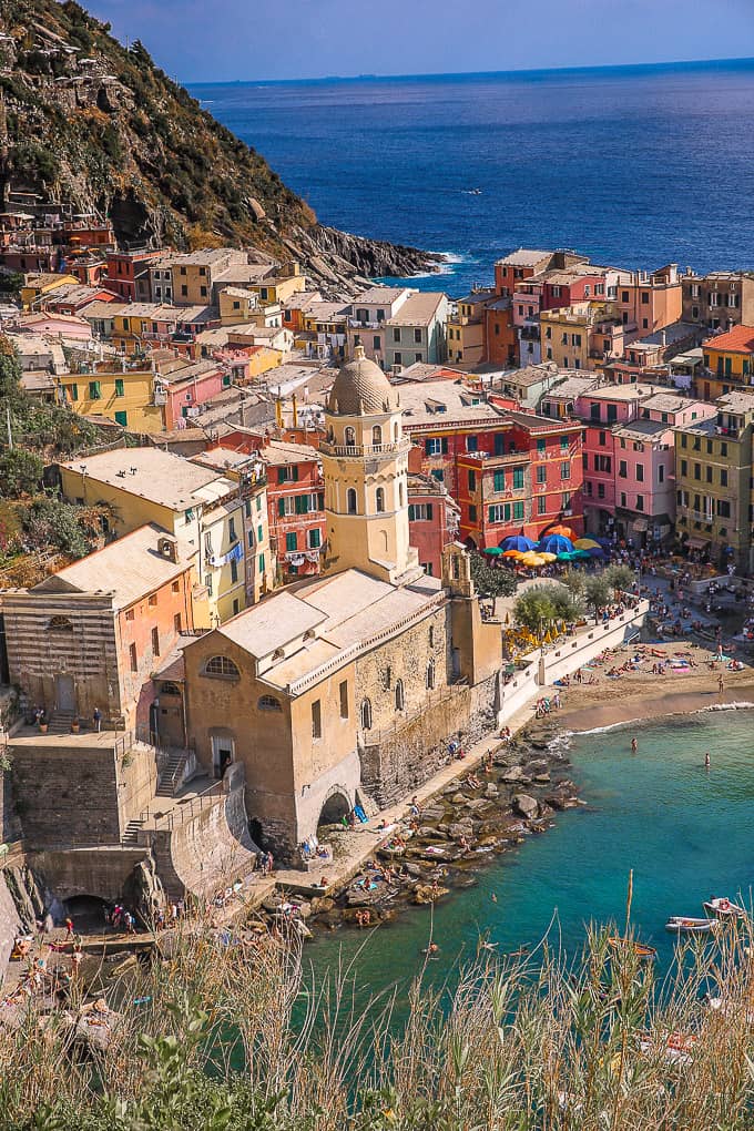 Colorful buildings and yellow tower overlooking the water in Cinque Terre