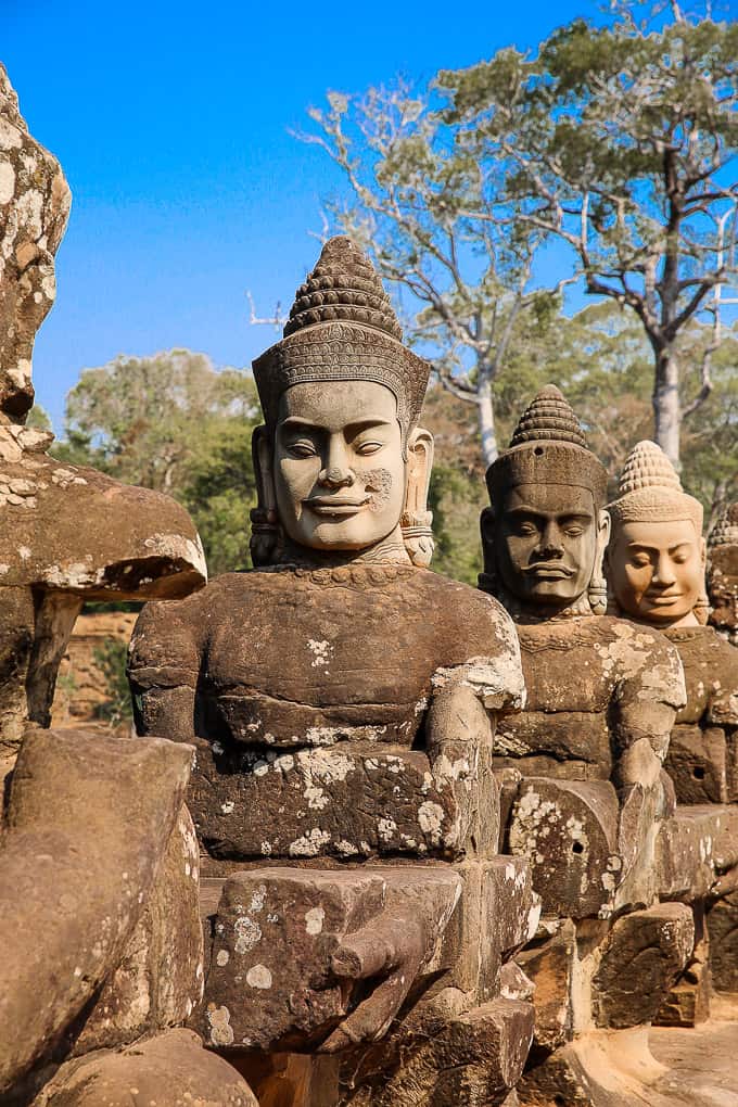 stone figures of mythical beings along the causeway over the moat to the South gate of Angkor Thom, Cambodia