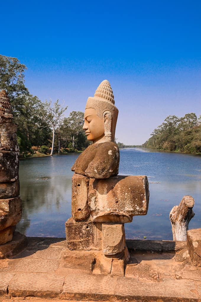 a stone figure along the causeway over the moat to the South gate of Angkor Thom, Cambodia