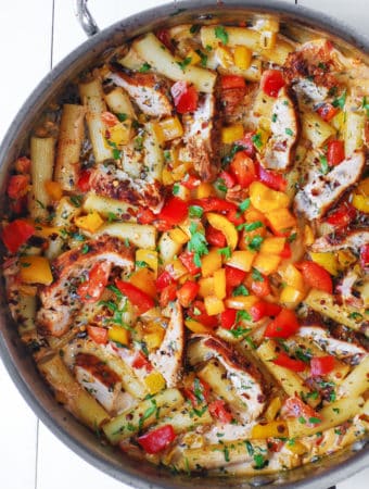 Creamy and spicy Cajun Chicken Pasta with Bell Peppers in a large stainless steel skillet