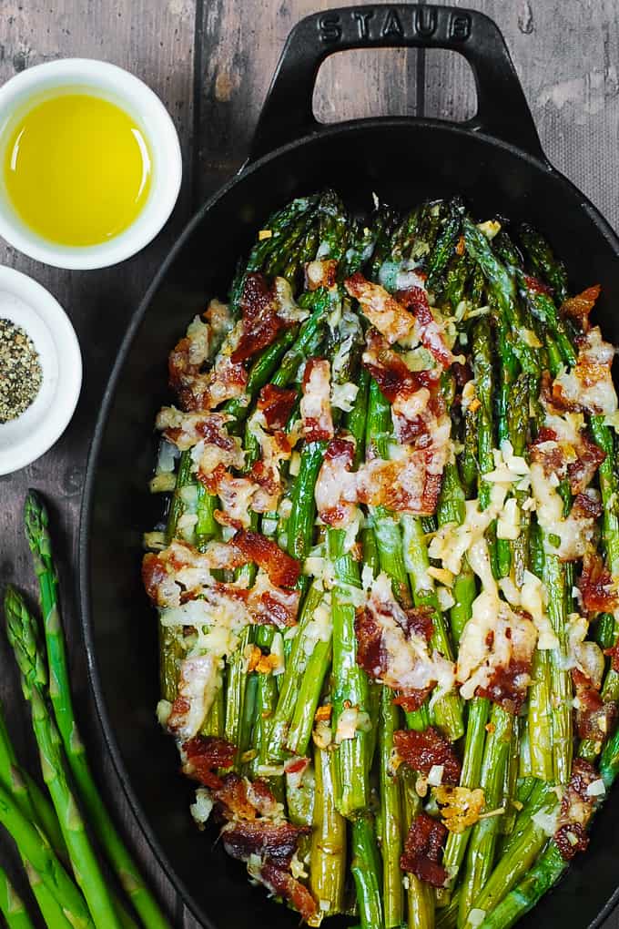 Cheesy Baked Asparagus in a cast-iron roasting dish