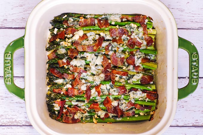 roasted asparagus with blue cheese and bacon in a baking dish