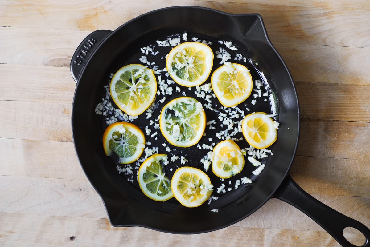 lemon slices and minced garlic in a cast iron skillet