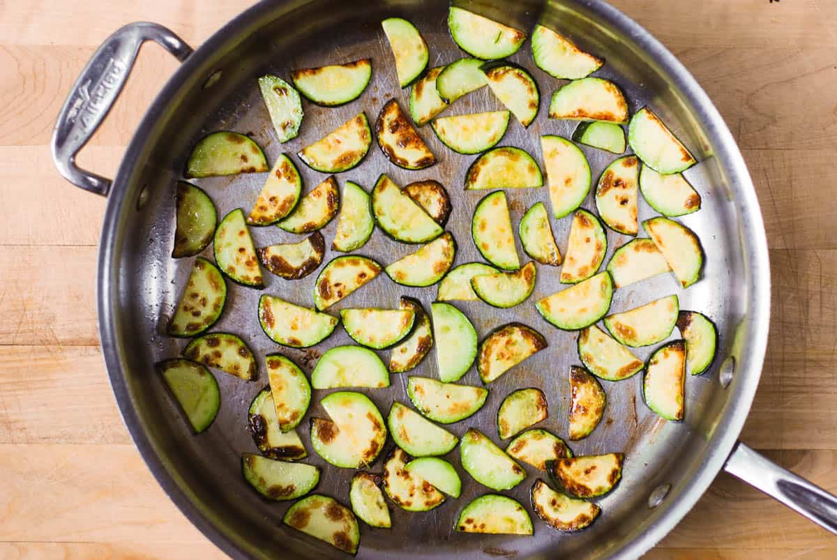 cooked sliced zucchini in a stainless steel pan
