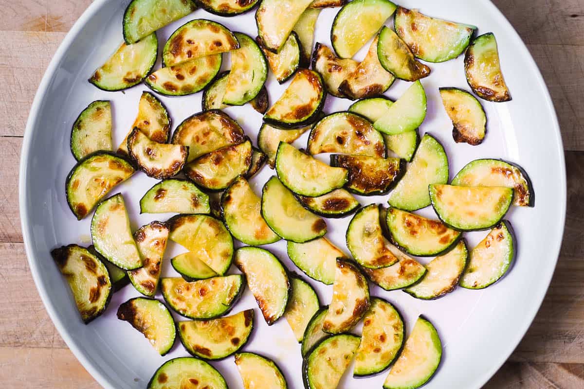 sliced cooked zucchini on a white plate