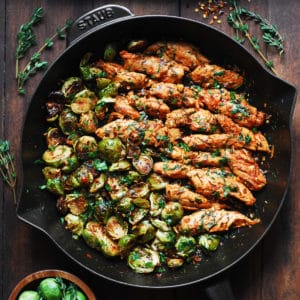 lemon garlic butter chicken and Brussels sprouts in a cast-iron skillet