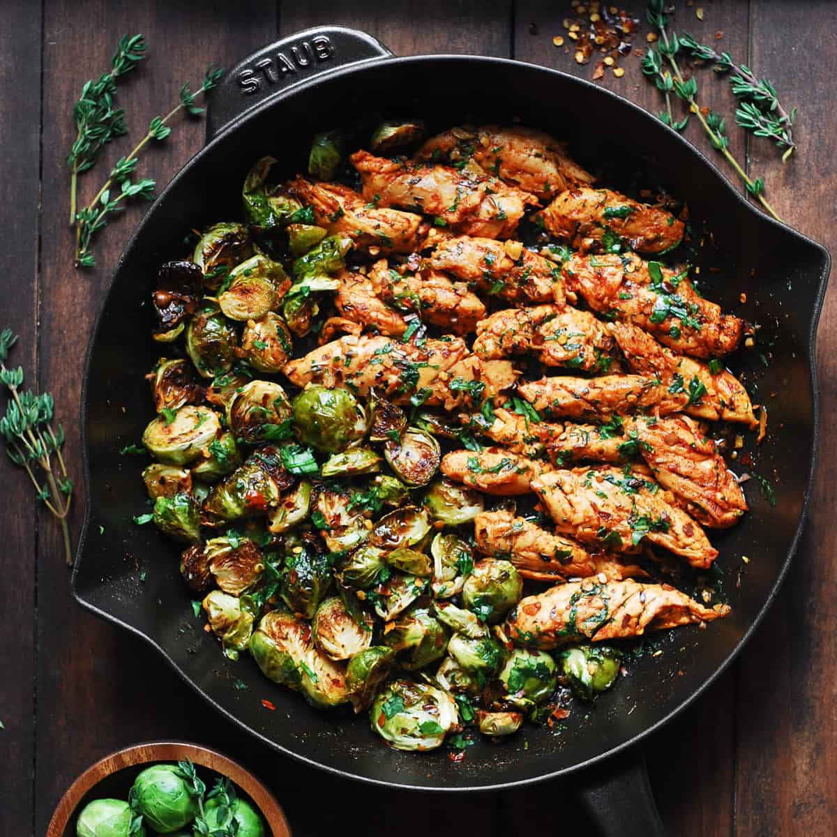 lemon garlic butter chicken and Brussels sprouts in a cast-iron skillet