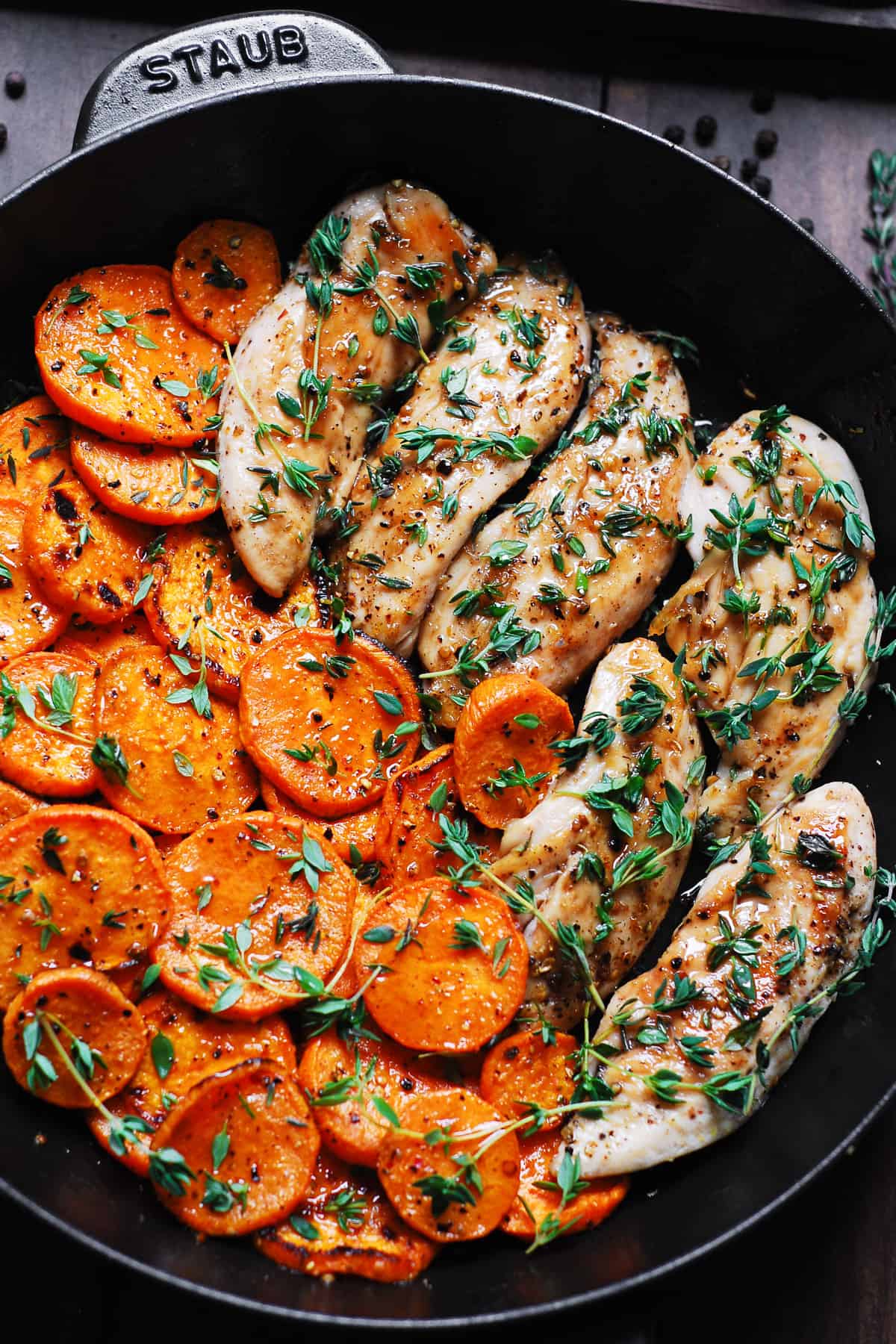 maple chicken with sweet potatoes and thyme in a cast-iron skillet