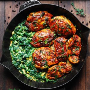 smoked paprika chicken with creamed spinach in a cast-iron skillet