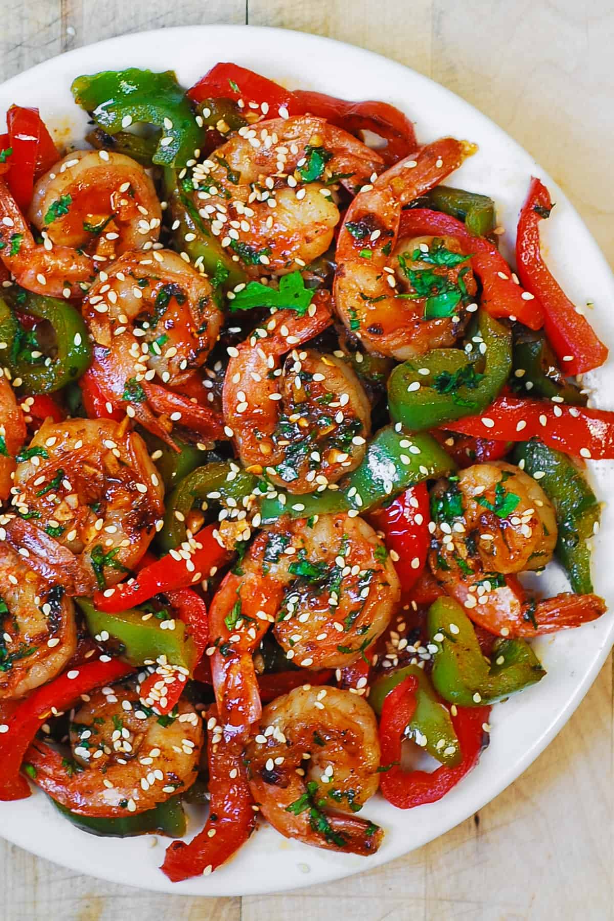 sweet chili shrimp with bell peppers on a white plate