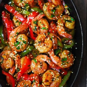 sweet chili shrimp with bell peppers in a cast iron skillet
