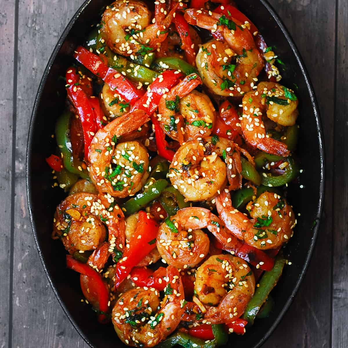 sweet chili shrimp with bell peppers in a cast iron skillet