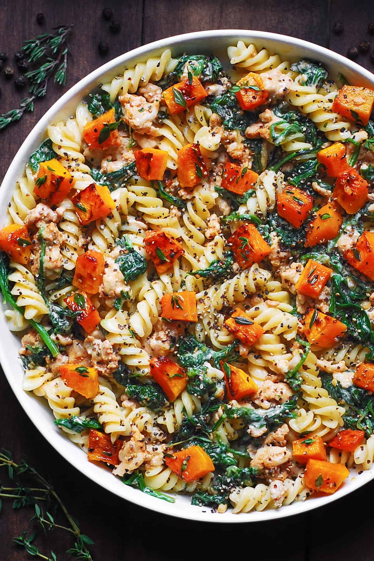 Creamy Ground Turkey Pasta with Butternut Squash and Spinach on a white plate