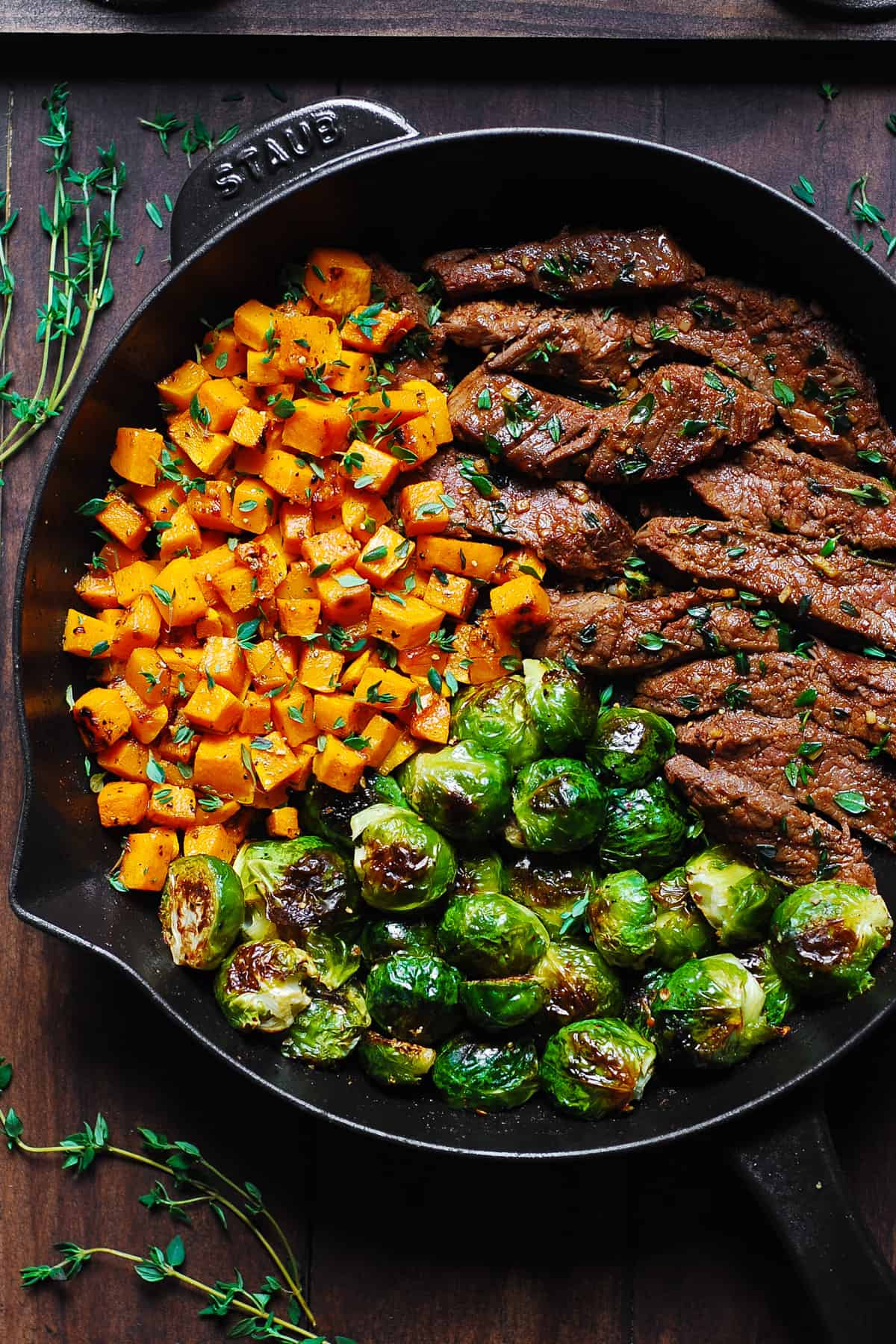 Garlic Butter Steak with Brussels Sprouts and Butternut Squash in a cast-iron skillet